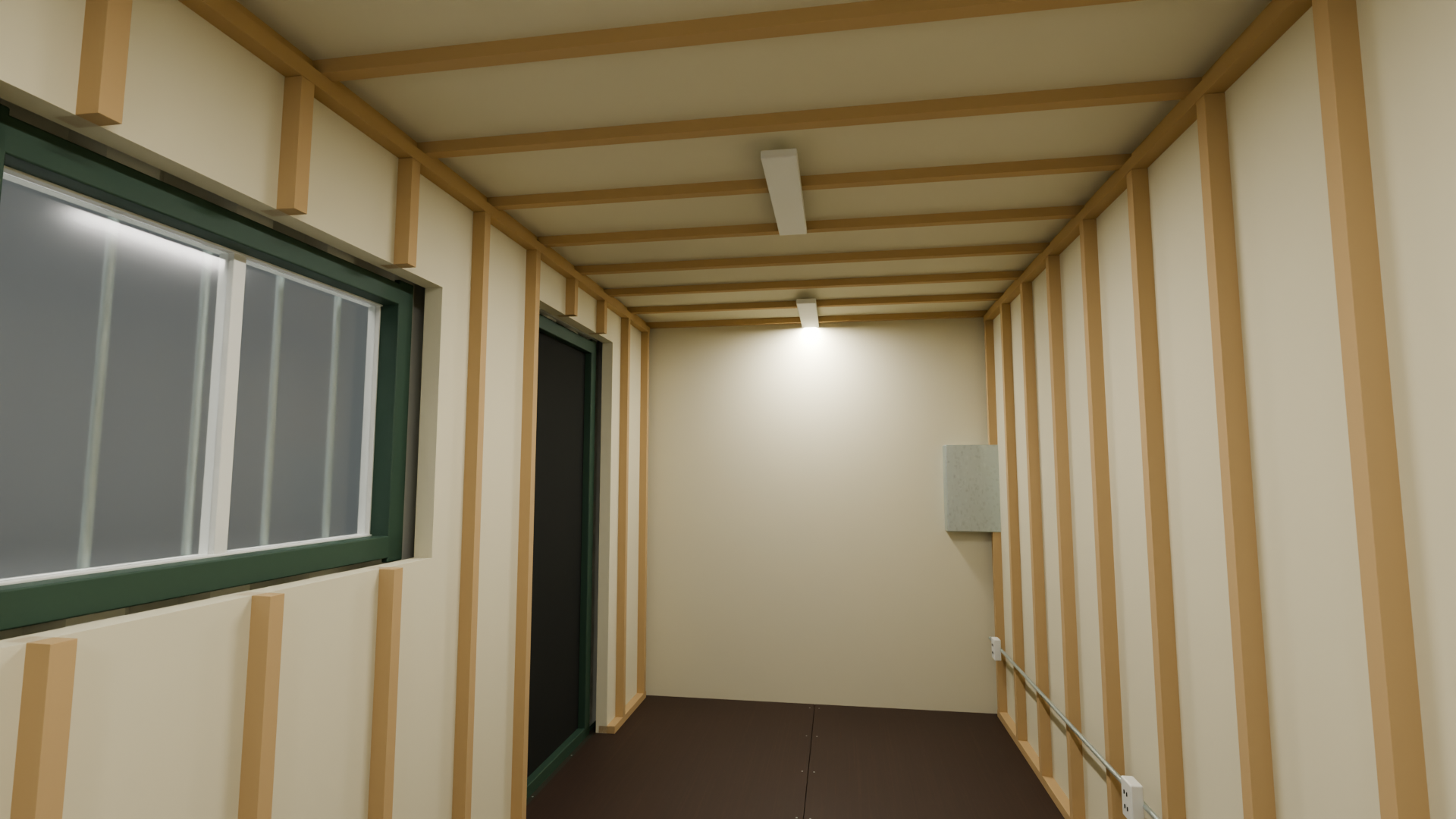 Interior of a 20-foot container build — wood framing, rigid foam insulation, ceiling LED lights, an open personnel door and a sliding window